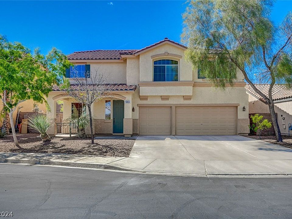 Two-story home with a two-car garage and wide driveway on a cul-de-sac at 1083 Royal Valley St in Henderson